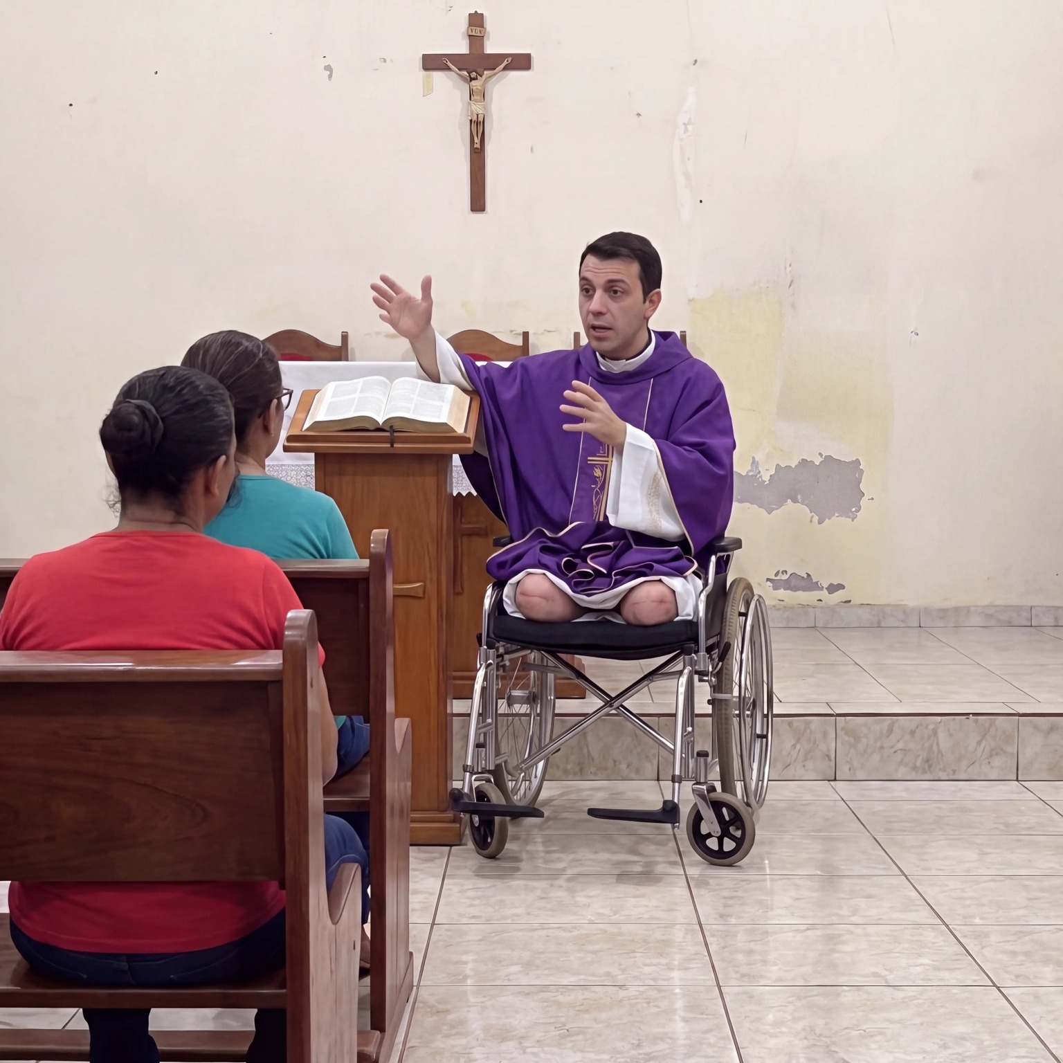 Father Miguel celebrating Mass while seated in his wheelchair